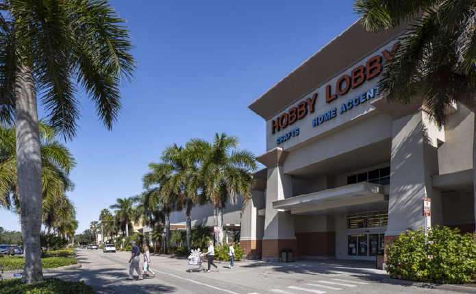 Hobby Lobby with palm trees and customers in front