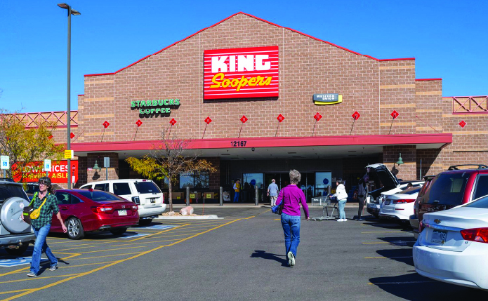 King Soopers and parking lot with customers approaching store.