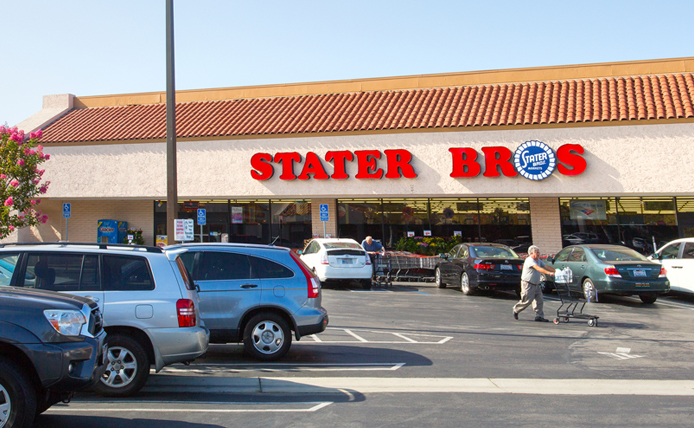 Stater Bros parking lot with customer pushing cart