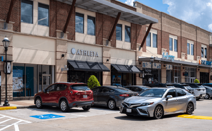 Busy parking lot at Athleta  and Teal Poppy storefront.