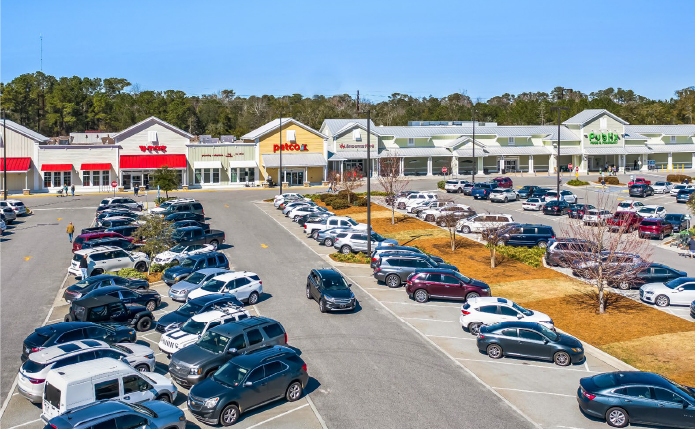 Full parking lot at Pawleys Island Plaza; competed acquisition