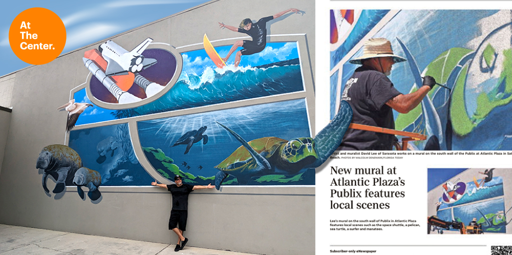 Artist poses with his aquatic and surfing mural.