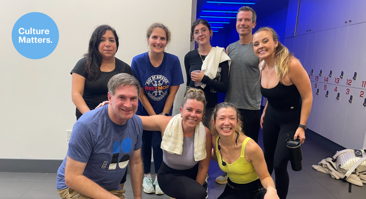 Group in athletic clothes posing at gym.