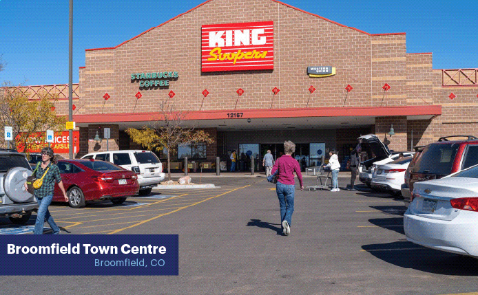 Customers approach King Soopers in busy parking lot.