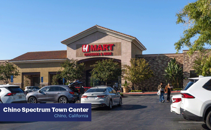 H-Mart with parking lot and trees on the right.