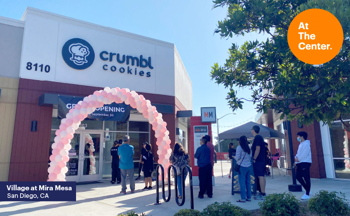 Crumbl cookies opening with balloons and line of customers