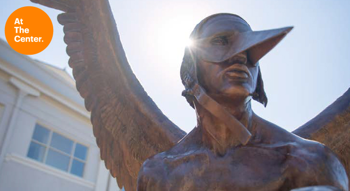 Wings of the City statue of a man with wings wearing a beak 
