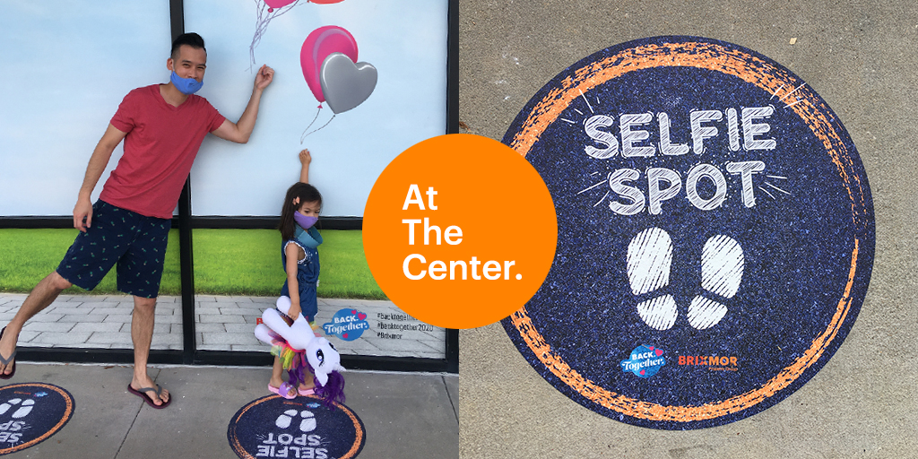 Man and child posing at selfie spot at Preston Ridge in Frisco TX