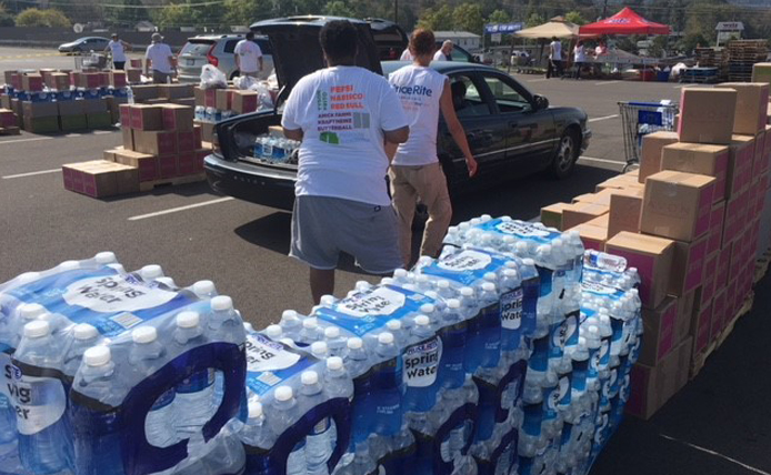 stockpile of water bottles in a parking lot