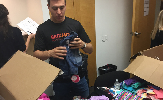 Brixmor employee packing a donation box