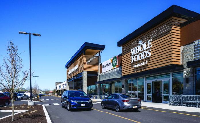 Cars passing on road at Whole Foods Market.