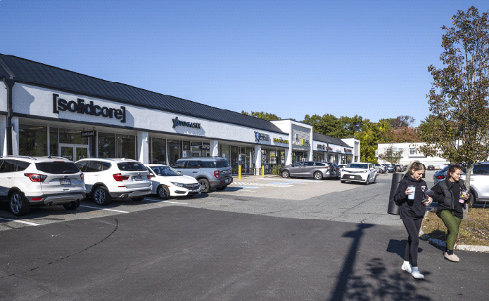 Solidcore and inline shops with 2 women in foreground.