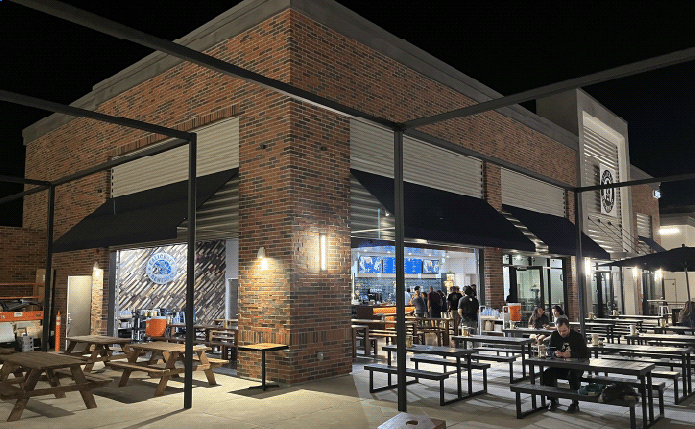 Calicraft Brewery with outdoor seating at night.