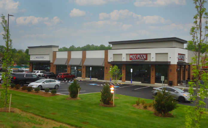 Mod Pizza surrounded by parking lot and green grass and trees.