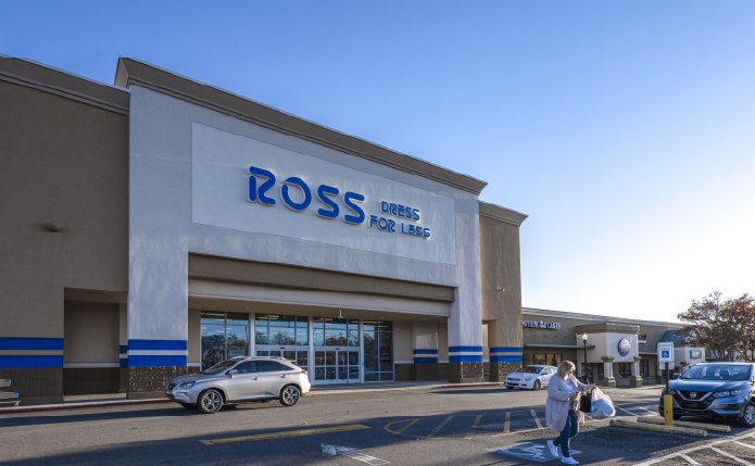 Ross store with patron in sidewalk and SUV at storefront.