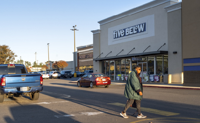 Five Below with red car and customer in front.