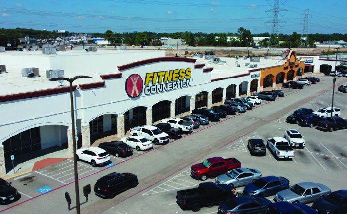 Aerial view of Fitness Connection with busy parking lot.