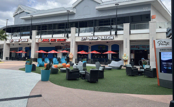 Seating and umbrellas in front of Dick's Last Resort.