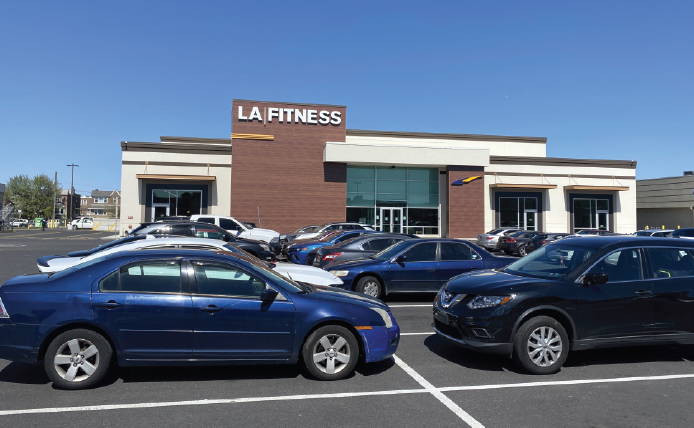 Full parking lot in front of LA Fitness at Roosevelt Mall shopping center