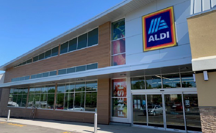 Sliding doors entrance of Aldi at outdoor shopping center in Roseville, Minnesota