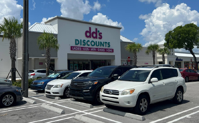 Row of parked cars in front of dd's Discounts.