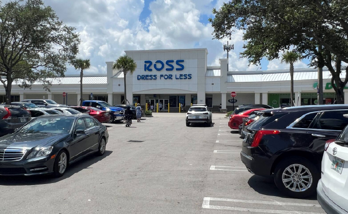 Ross store with parking lot and cars driving up and down access road.