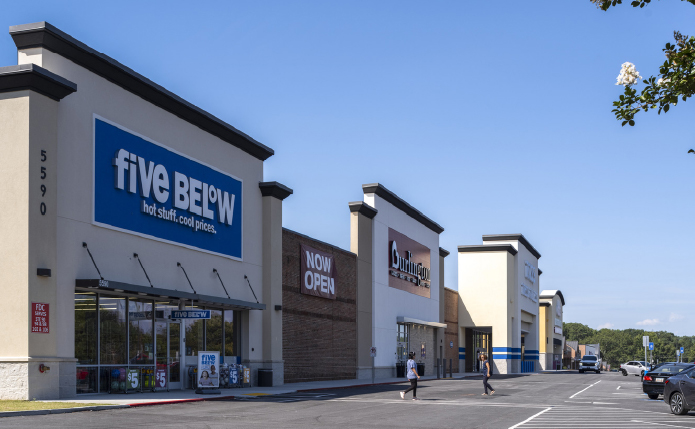 Five Below store front with patrons walking in front on access road.