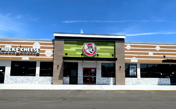 Chuck E. Cheese entrance in shopping center.