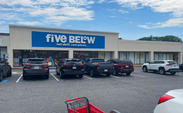 Five Below with parked cars in front of store.