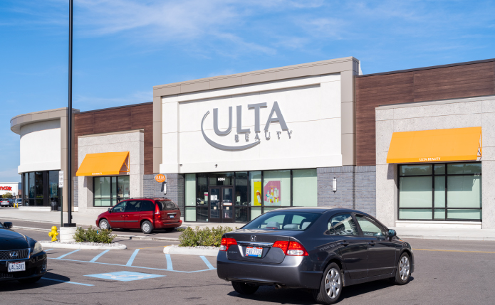 Black car driving in front of Ulta at Western Hills Plaza shopping center in Cincinnati, Ohio