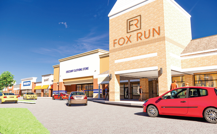 Red car pulling in front of Fox Run outdoor shopping center