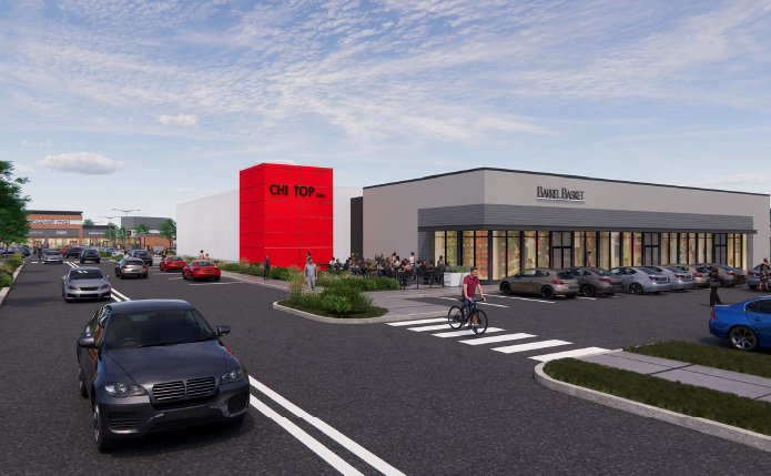 Rendering of cars on road passing red and grey buildings in shopping center.