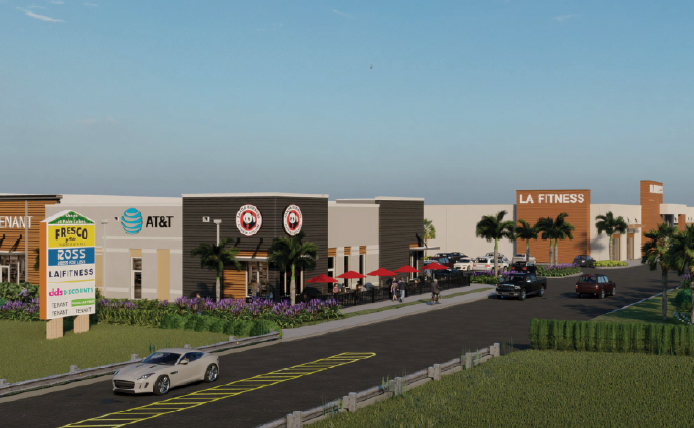 White car driving down entrance to Shops of Palm Lakes outdoor shopping center