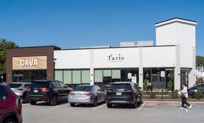 CAVA and Tatte Bakery & Café storefronts at Burlington Square in Burlington, MA, featuring a modern retail center façade and a busy parking area at this high‑traffic shopping plaza.