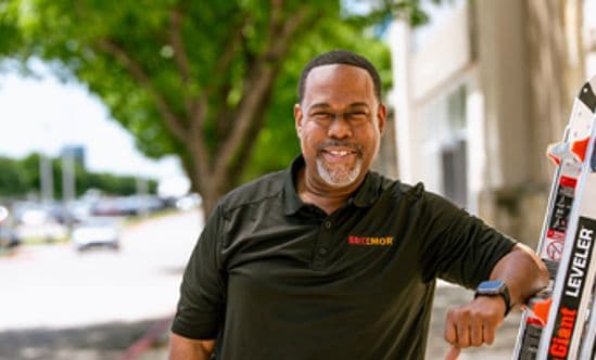 Close up of a facility manager wearing a Brixmor shirt outside at a shopping center