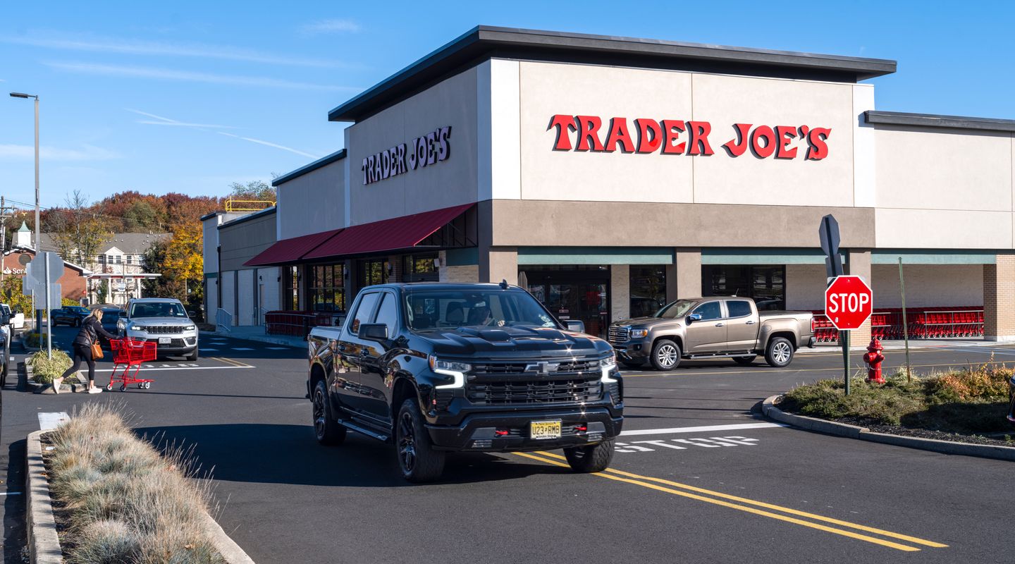 Trader Joe’s at Middletown Plaza in Middletown, NJ, featuring a clean modern façade with bold red signage, large front windows, surrounding parking area, and landscaped edges under a bright clear sky.