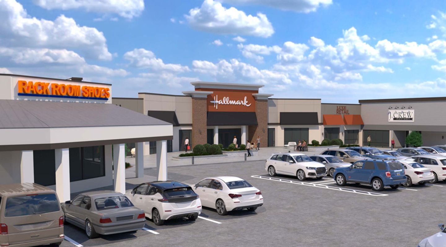 3D perspective rendering of Hillcrest Market Place in Spartanburg, SC, showing proposed façade upgrades for Hallmark, Rack Room Shoes, and J.Crew Factory, with enhanced architectural details, expanded storefront glass, new signage, and an active parking lot in the foreground.
