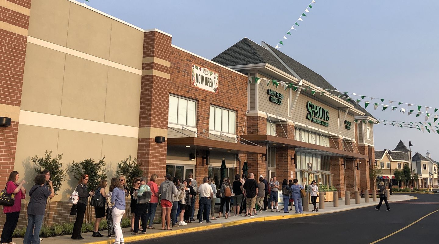 People lined up on the sidewalk waiting to enter Sprouts Farmers Market on their first day at Marlton Crossing