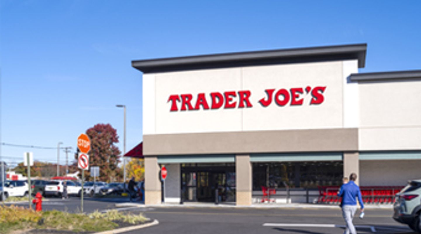 Trader Joe’s at Middletown Plaza in Middletown, NJ, featuring a clean modern façade with bold red signage, large front windows, surrounding parking area, and landscaped edges under a bright clear sky.