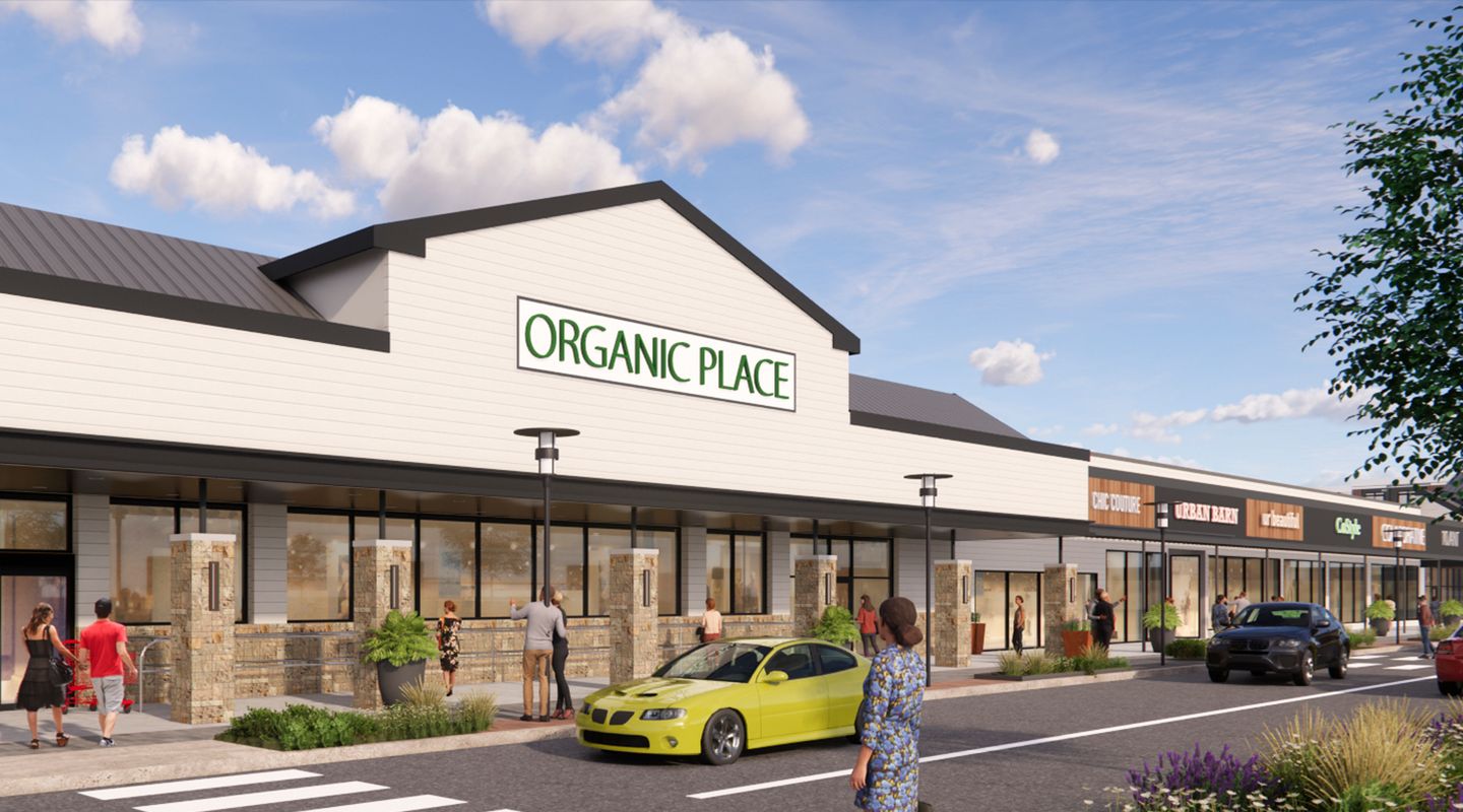 Rendering of the redeveloped Morris Hills Shopping Center featuring a grocer and a modernized retail streetscape with enhanced storefronts, upgraded façades, landscaping, pedestrian crosswalks, outdoor lighting, and convenient parking.