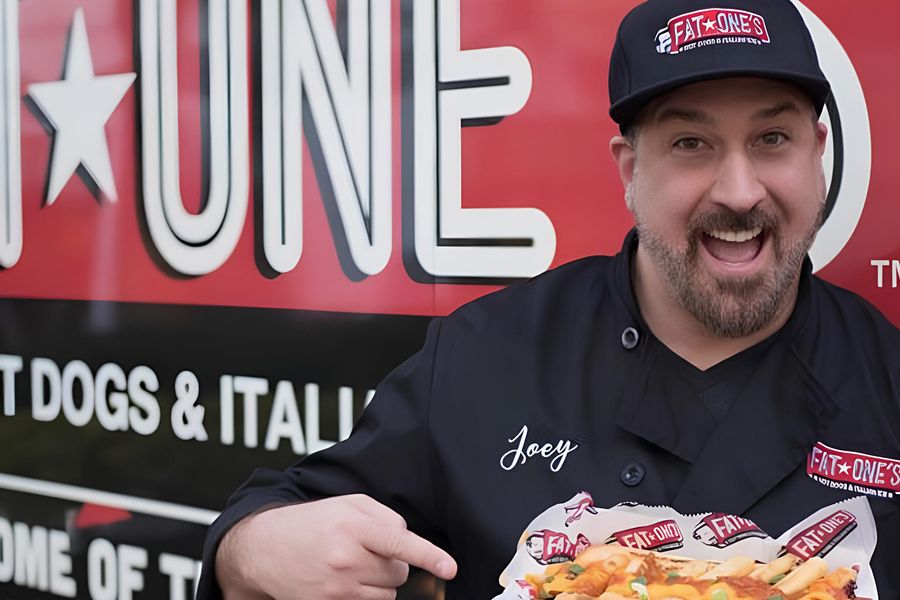 Close up of Joey Fatone pointed at food in front of a food truck