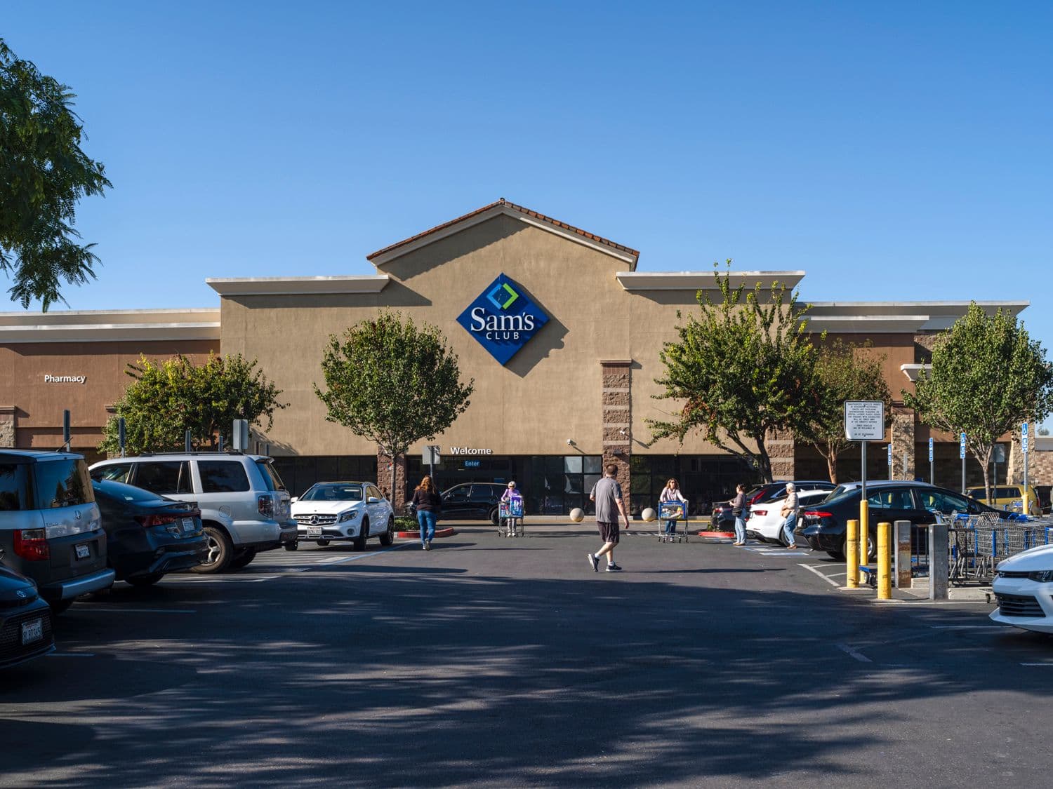 Parking lot of Sam's Club with trees at storefront